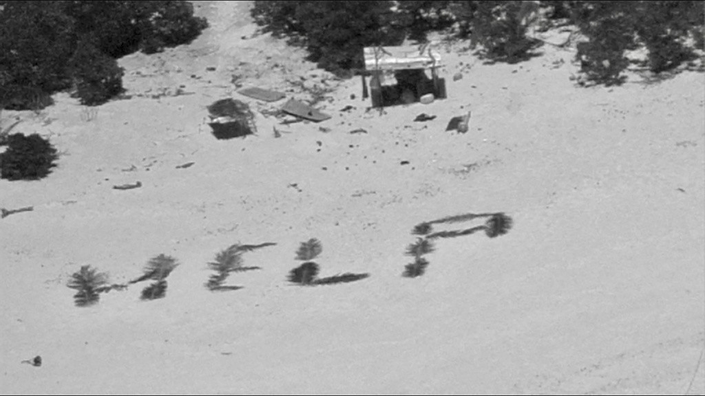 Esta imagen difundida por la Guardia Costera de Estados Unidos muestra la palabra 'Help' ('Ayuda') que tres marinos náufragos formaron con hojas de palmera, el lunes 8 de abril de 2024, en el atolón Pikelot, en los Estados Federados de Micronesia. (Guardia