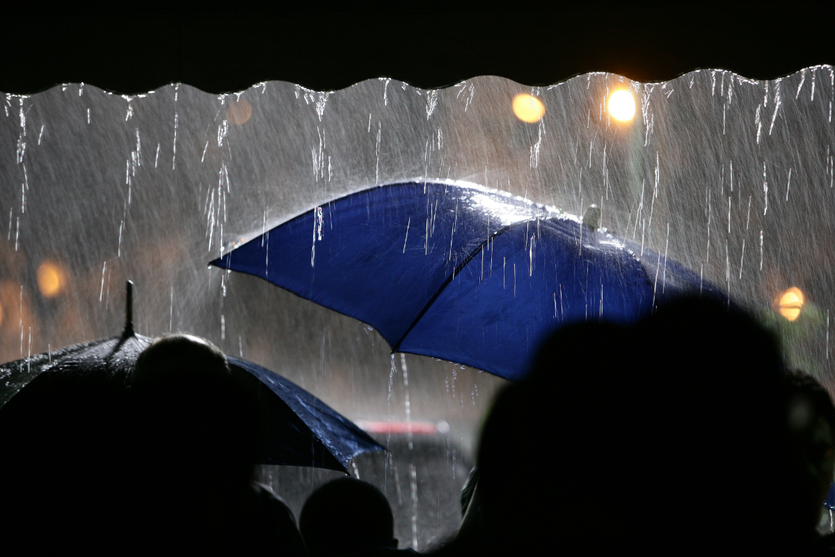 Personas protegiéndose de lluvia. Foto: EdYazbeck