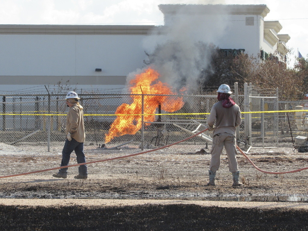 Trabajadores laboran cerca del lugar donde se incendió un oleoducto, el jueves 19 de septiembre de 2024, en Deer Park, Texas. (AP Foto/Juan A. Lozano)