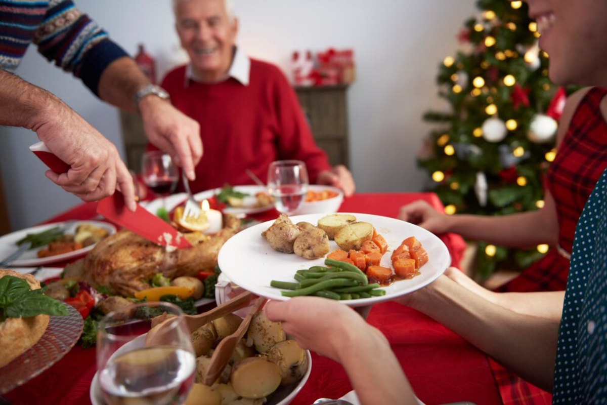 Personas en una Cena de Navidad.    Foto: Freepik editada en Canva.