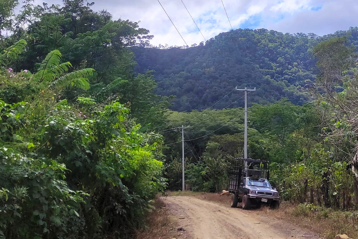 Paraje que muestra un camino de terracería, con una camioneta de redilas estacionada y, al fondo, unas montañas en Chicomuselo, Chiapas. Foto: Facebook/H. Ayuntamiento de Chicomuselo 2021 - 2024